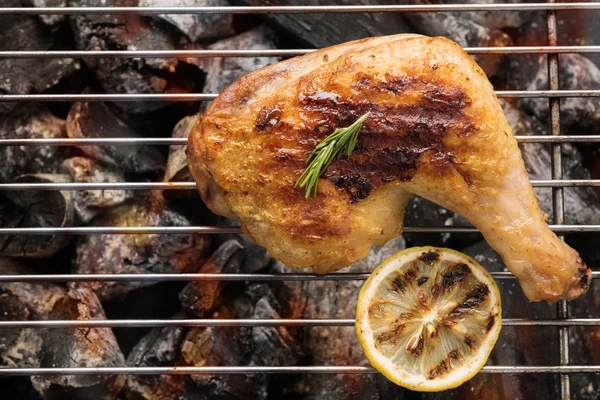 Grilled chicken leg over flames on a barbecue — Stock Photo, Image