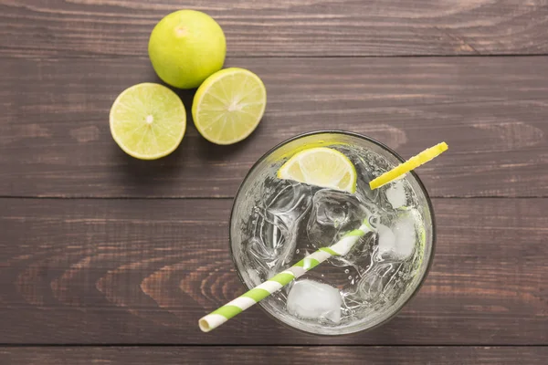 Fresh cocktail with soda, lime on a wooden background — Stock Photo, Image
