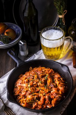Vintage bir kızartma tavası ve bir kupa bira ile haşlanmış lahana. 