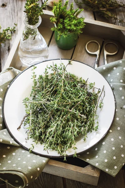 Thyme in vintage plate in wooden box. — Stock Photo, Image