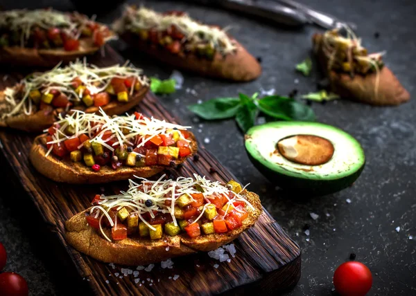 Bruschettas with tomatoe and avocado. — Stock Photo, Image