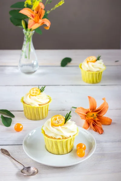 Cupcakes mit Frischkäse auf weißem Holztisch. — Stockfoto