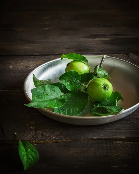 Verse groene appels met bladeren op donkere rusric achtergrond. — Stockfoto