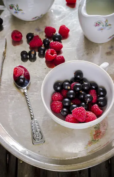 Bayas de verano en taza blanca en bandeja metálica vieja . — Foto de Stock