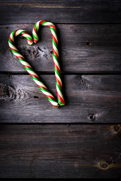 Christmas sugar candies on dark wooden background. — Stock Photo, Image