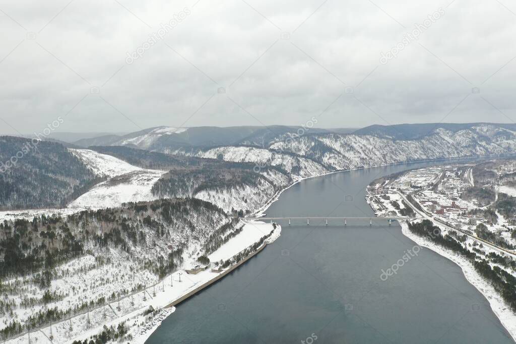 Krasnoyarsk dam and power plant on Enisey river from aerial view. Krasnoyarsk reservoir. Mountains landscape