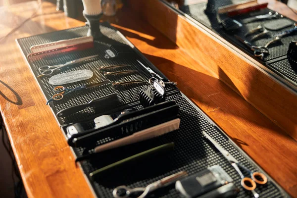 Collection of hairdressing tools on wooden desk