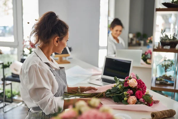 Hard-working woman making a presentable fancy bouquet