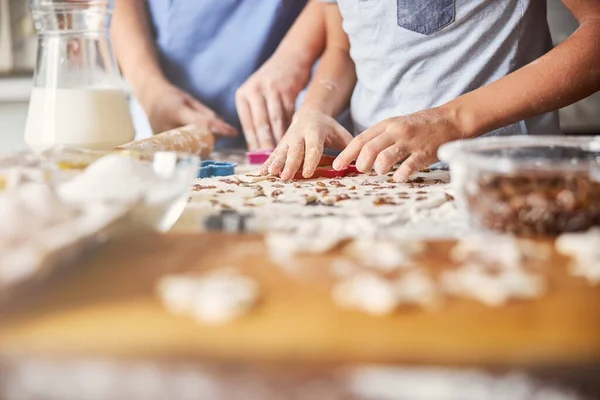 Діти ретельно формують тісто в печиво за столом — стокове фото