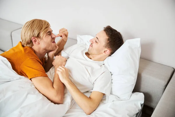 Glücklich gay pärchen liegen im bett und haben spaß — Stockfoto