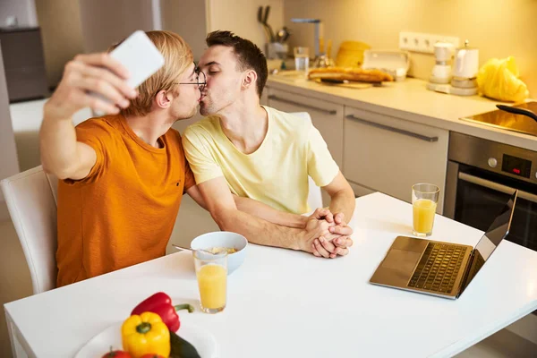 快乐的同性恋情侣在家里接吻和自拍 — 图库照片