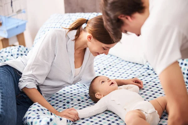 Genitori felici che fanno massaggi per il loro bambino Foto Stock Royalty Free