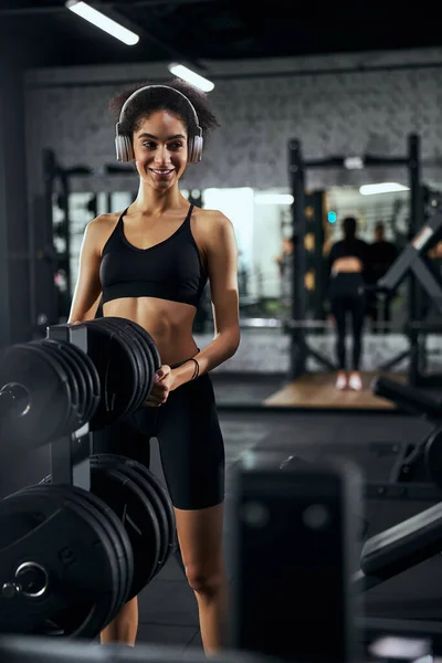 Positive delighted young brunette working in gym — Stock Photo, Image