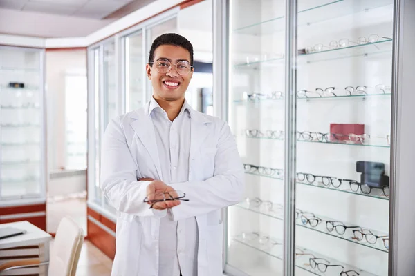 Glimlachende optometrist biedt trendy glazen aan klanten — Stockfoto