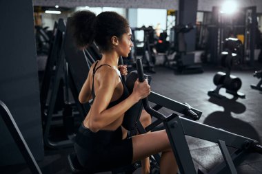 Yoğunlaşmış esmer kadın vücudunu güçlendiriyor.