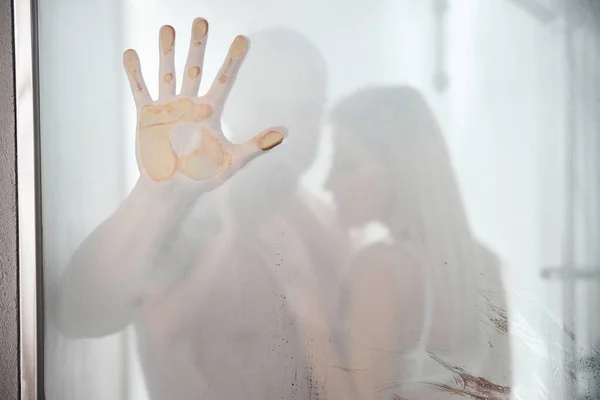 Married couple standing behind the steamy glass — Stock Photo, Image