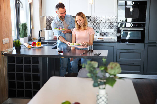 Beautiful happy couple enjoying lunch at home