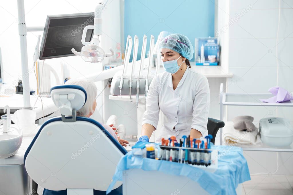 Dentist searching for something at the instrument table