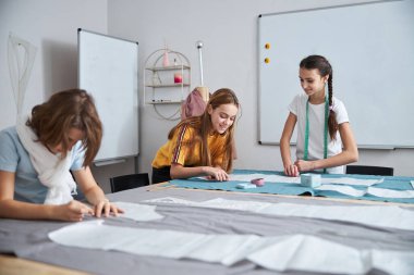 Dikiş atölyesinde çalışan neşeli tatlı kızlar.