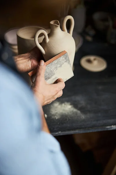 Жіночий гончарний полірування глиняного горщика в керамічній майстерні — стокове фото