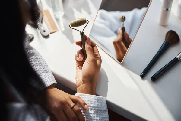 Female hands holding natural stone massage roller — Stock Photo, Image