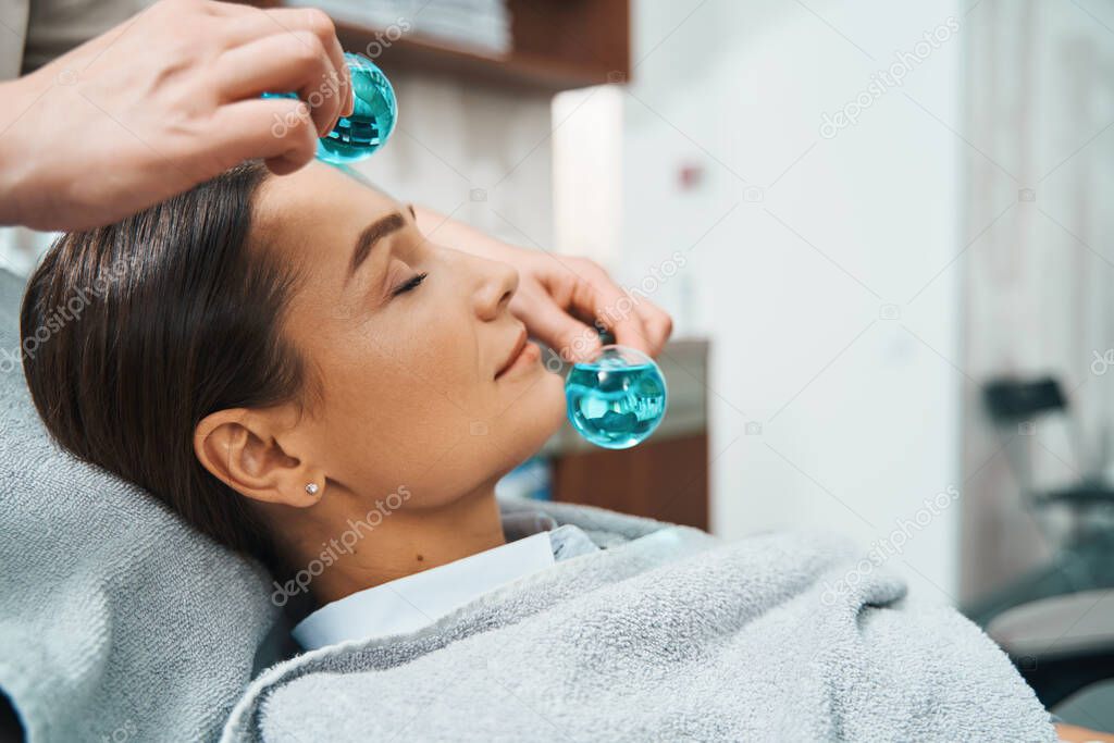 Lovely client dozing during a cosmetic procedure