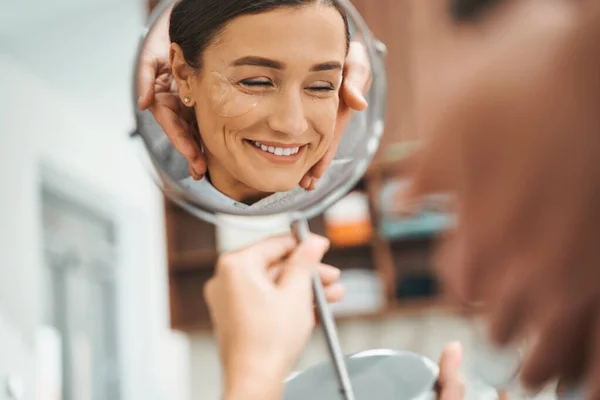 Smiling pleased spa client with a handglass — Stock Photo, Image