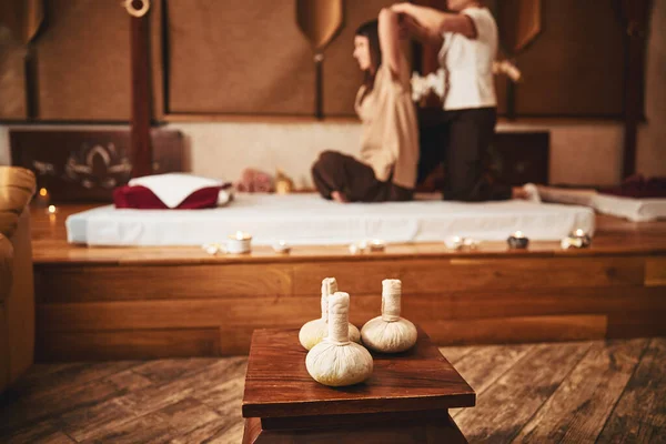 Three thai herbal compress balls lying on stool — Stock Photo, Image