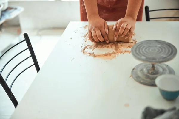 Jeune femme mains pétrissant de l'argile en atelier de poterie — Photo