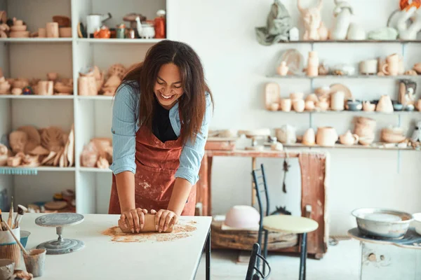 Весела молода жінка працює в керамічній майстерні — стокове фото