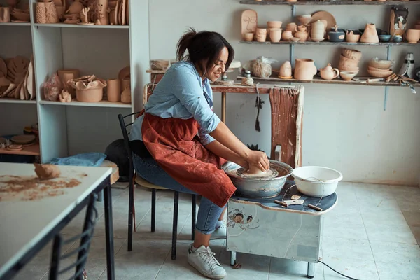 Beautiful young woman making pottery in workshop — Stock Photo, Image