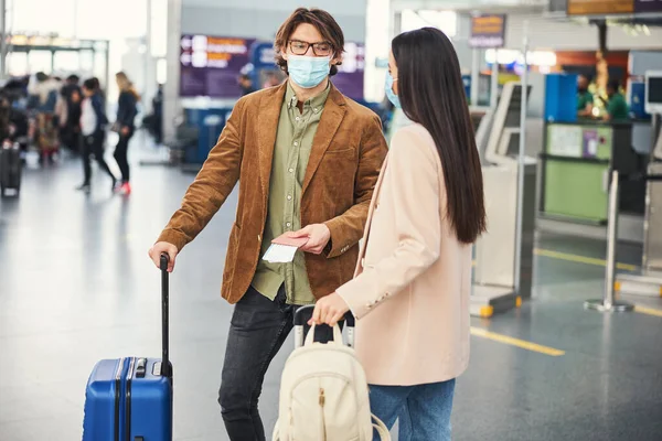 空港に立っている医療面マスクの若い男と女 — ストック写真