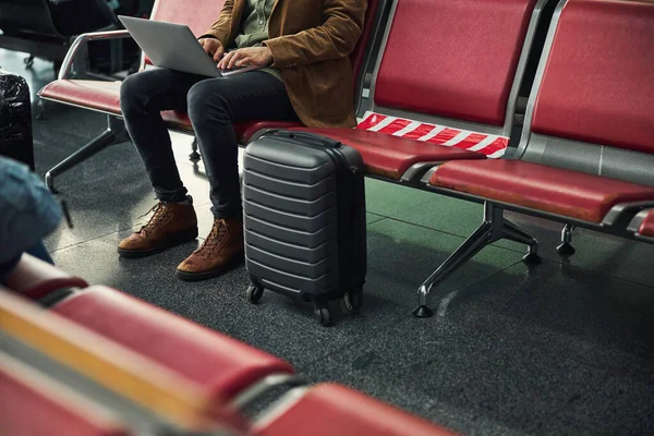 공항에서 노트북으로 일하는 멋진 젊은이 — 스톡 사진