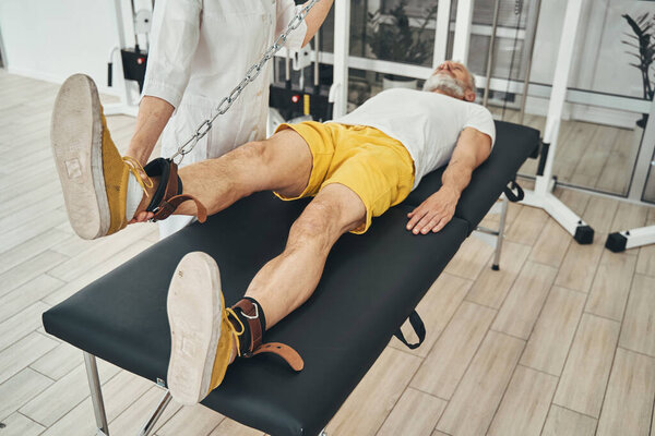 Man lying on the couch during the physiotherapy session