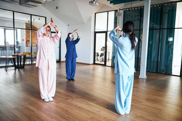 Τρεις γυναίκες που ασκούν συγκεκριμένες στάσεις σώματος του qigong — Φωτογραφία Αρχείου