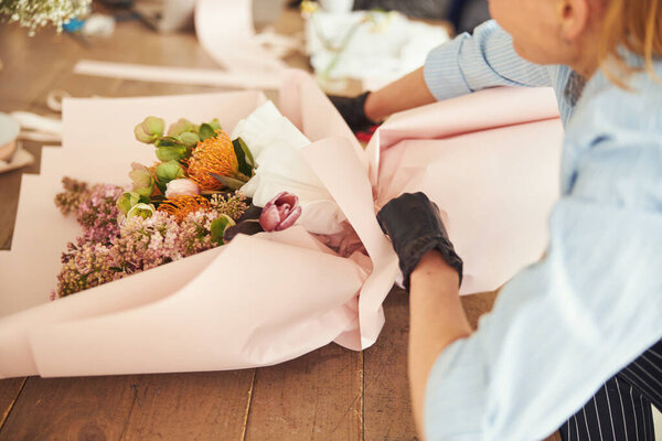 Skilled florist finishing off a floral arrangement