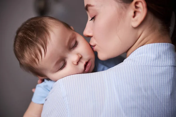 Portrait of tender woman kissing her child — Stock Photo, Image