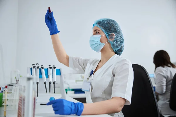 Tecnico di laboratorio in guanti di lattice sterili con un tubo vacutainer — Foto Stock