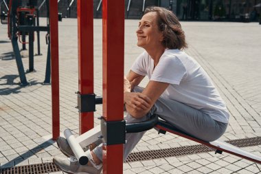 Mutlu yaşlı kadın açık havada antrenman yapmaktan hoşlanıyor.