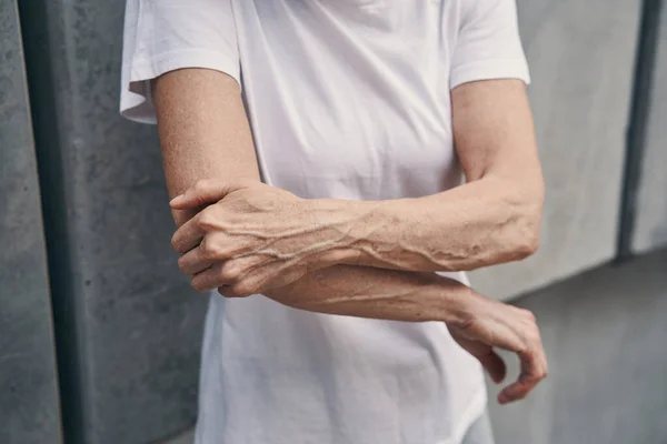 Mature sportswoman feeling pain in arm while jogging —  Fotos de Stock