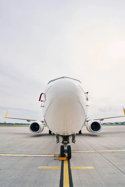 Nose of a landed civil aircraft parked on the runway — Stock Photo, Image