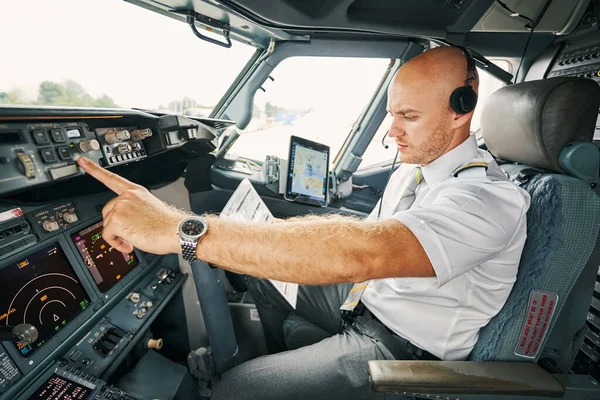 Experienced aviator checking flight controls before the departure — Stock Photo, Image