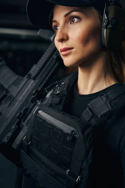 Mujer pensativa con un arma de fuego mirando a la distancia —  Fotos de Stock