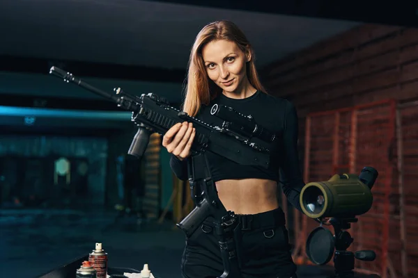 Sparatutto femminile pulizia suo fucile d'assalto prima della fotocamera — Foto Stock