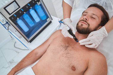 Cilt soyma işlemi sırasında genç bir hasta uyukluyor.