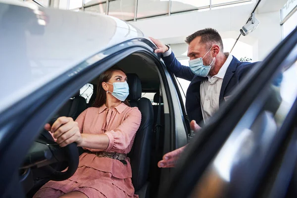 Car salesman working with his female customer — Stock Photo, Image