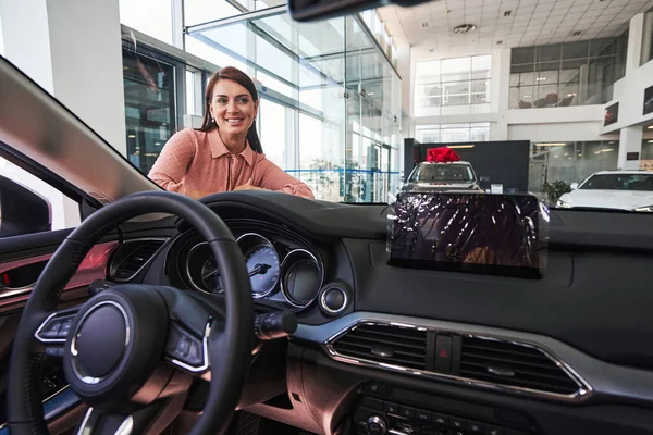 Happy lady admiring her new mean of transport — Stock Photo, Image