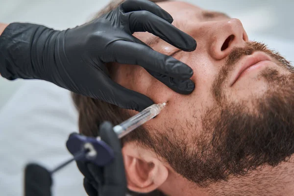 Caucasian male patient undergoing a mesotherapy procedure — Stock Photo, Image