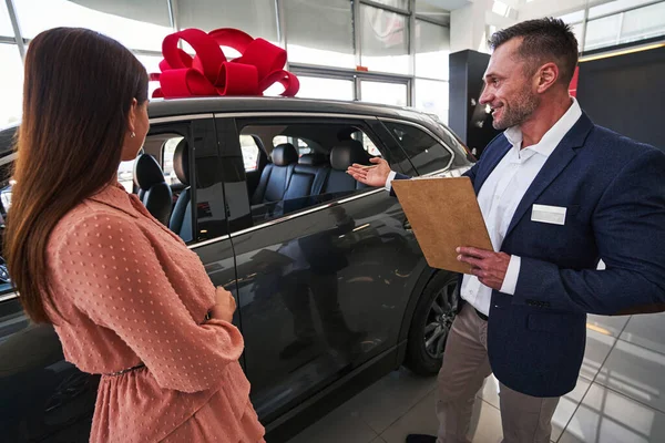 Big new car decorated as the present in the salon — Stock Photo, Image
