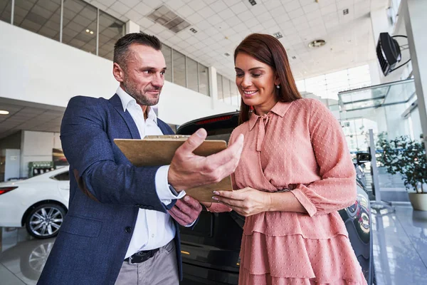 Satisfied client of the modern car showroom — Stock Photo, Image